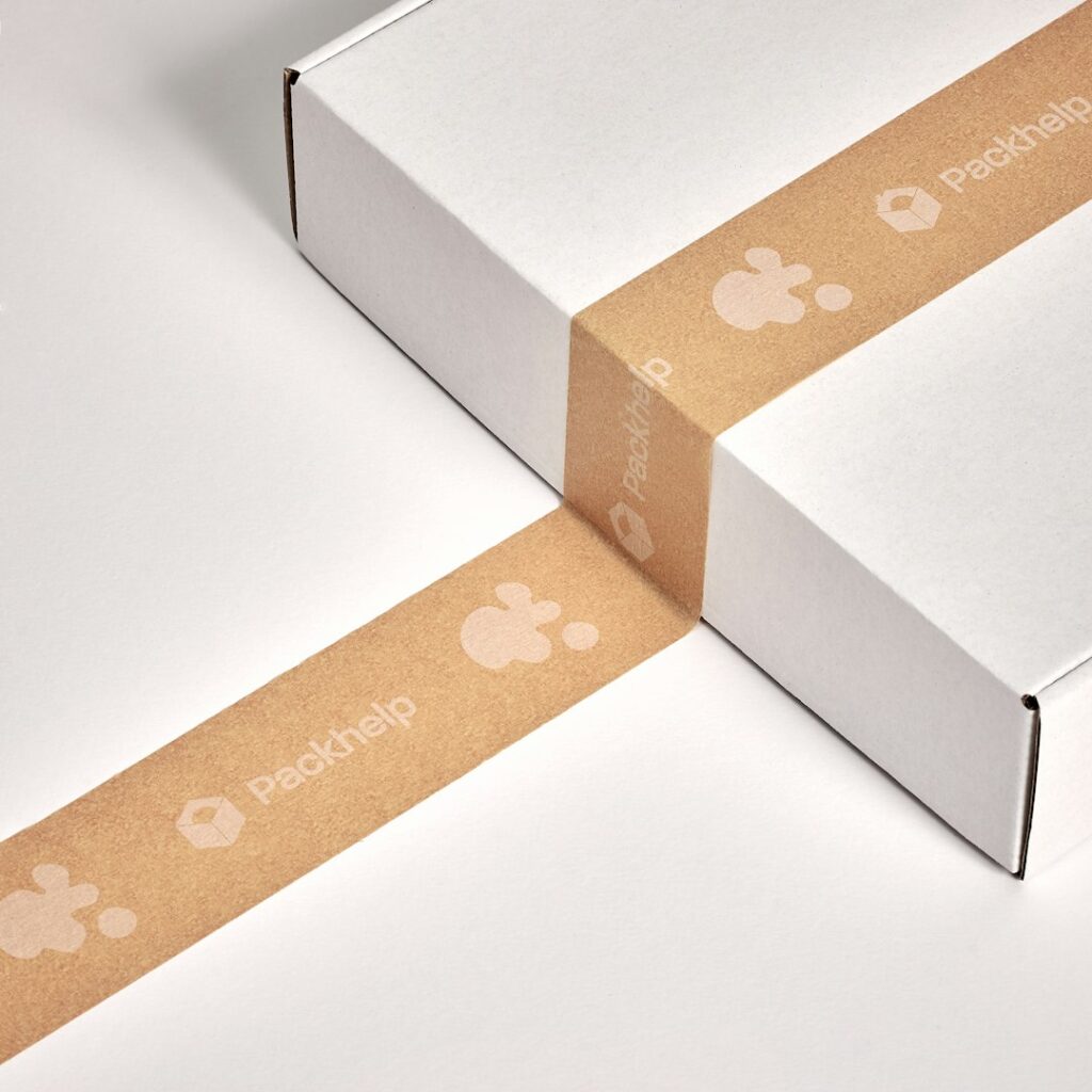 Person measuring a unique-shaped item and placing it inside a fitted cardboard box with packing materials.